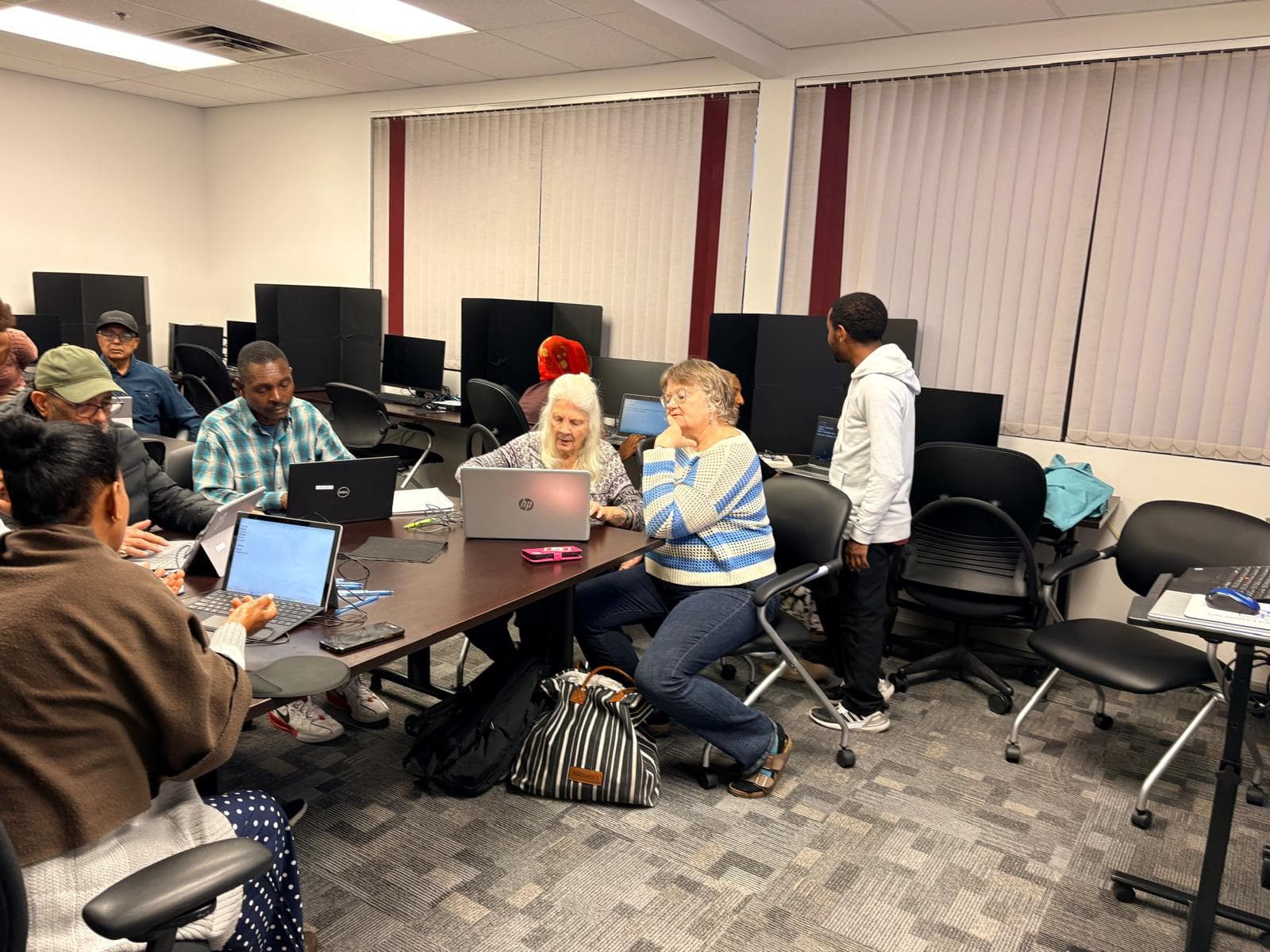 Seniors learning computers with a patient instructor