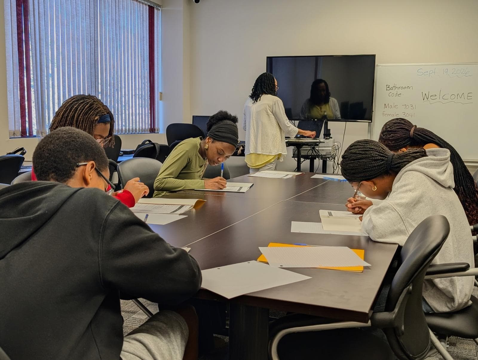 Youth learners working together with an instructor